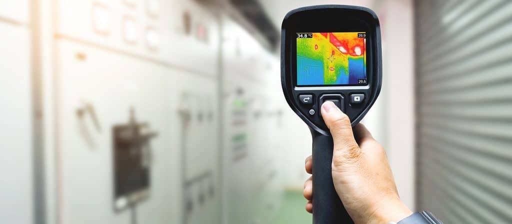 technician use thermal imaging camera to check temperature in fa